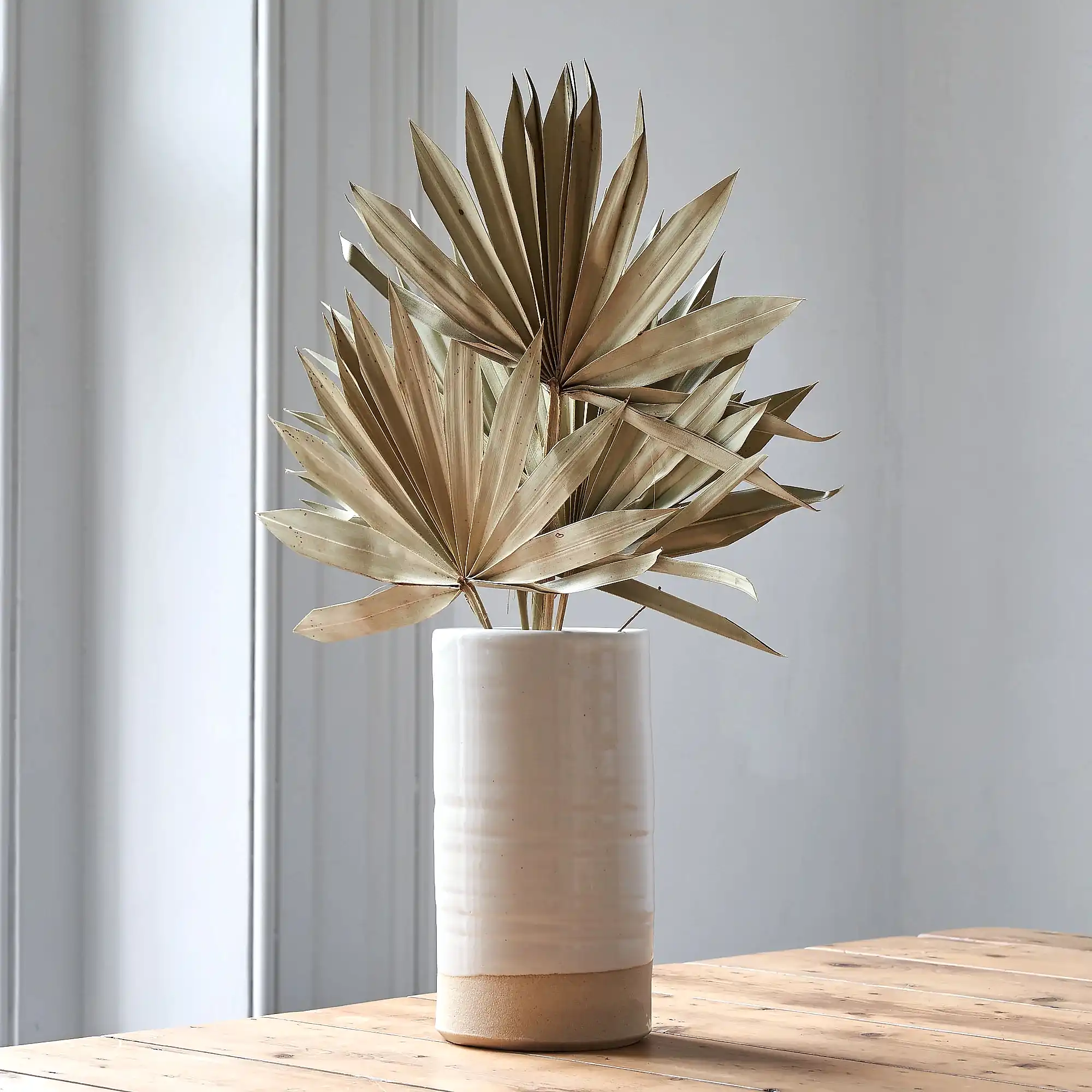 dried palm leaves in ceramic vase